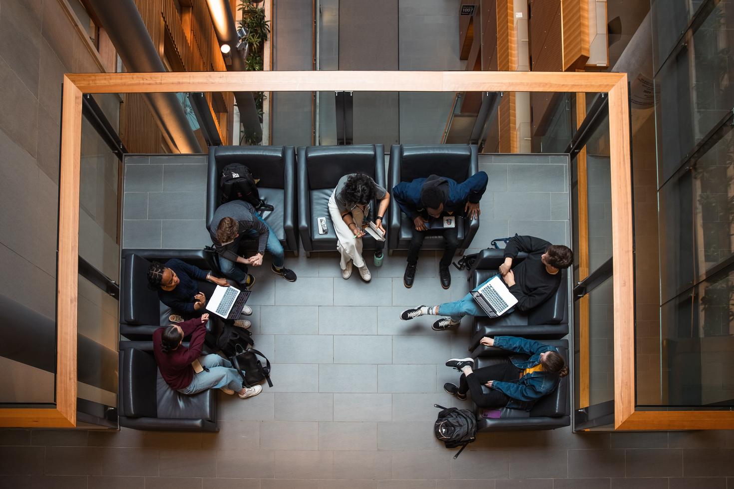 A group of students working together, seen from above. 