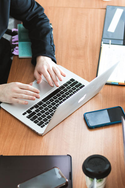 Student typing on a laptop