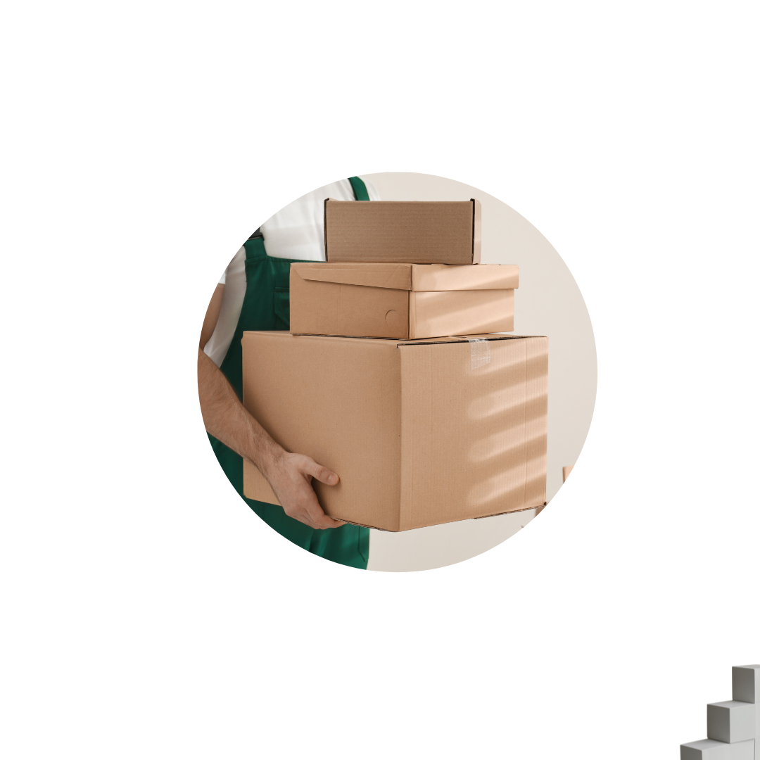 A man holds a box while standing in front of a white background, emphasizing his action.
