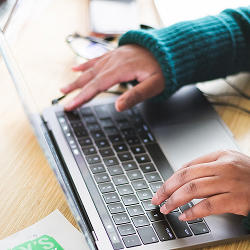 A person typing on a laptop