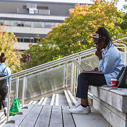 A student sitting on some steps studying