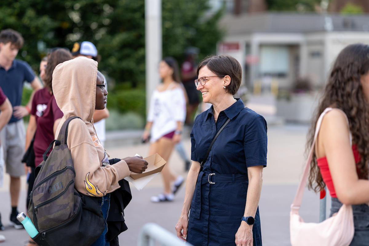 Marie-Eve Sylvestre, president, talking with an international student