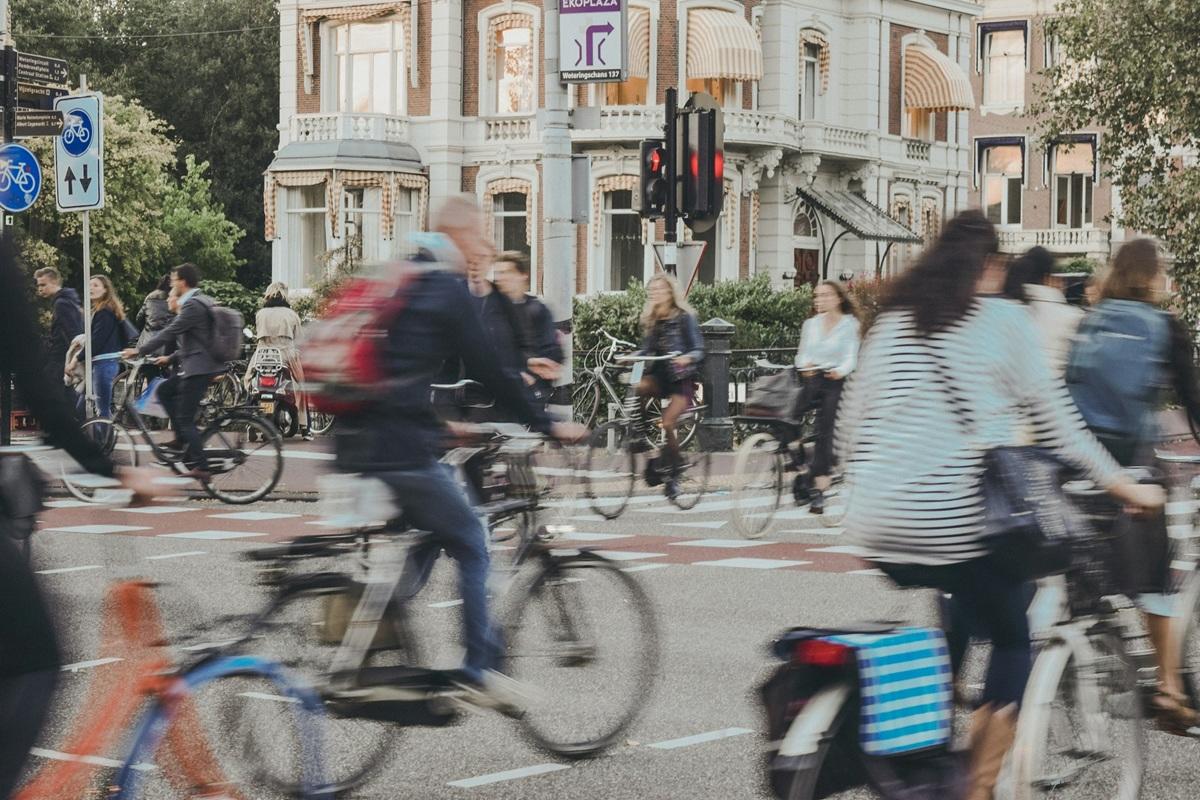 Cyclists pedaling through a busy intersection