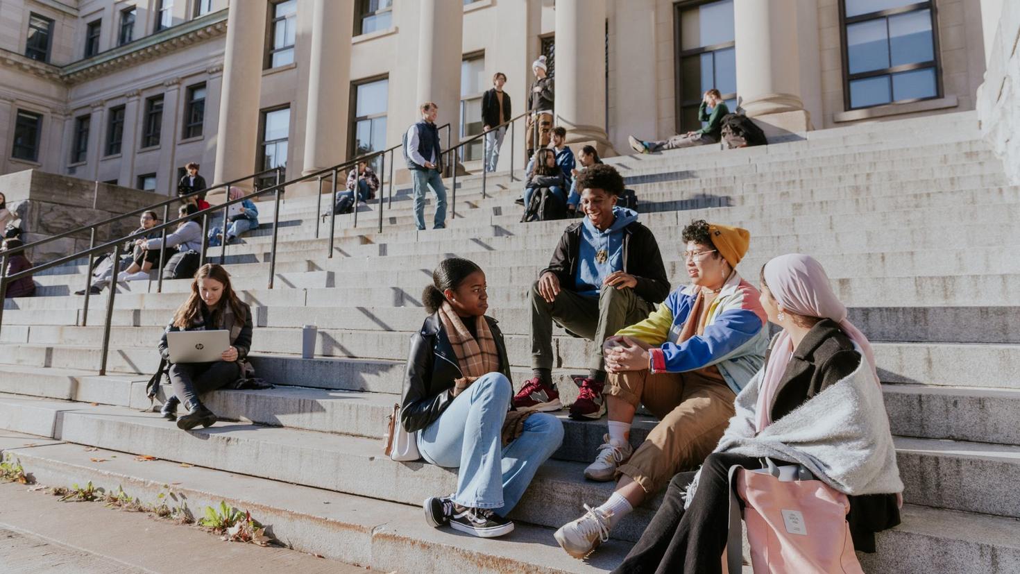 Students sitting on the steps of Tabaret