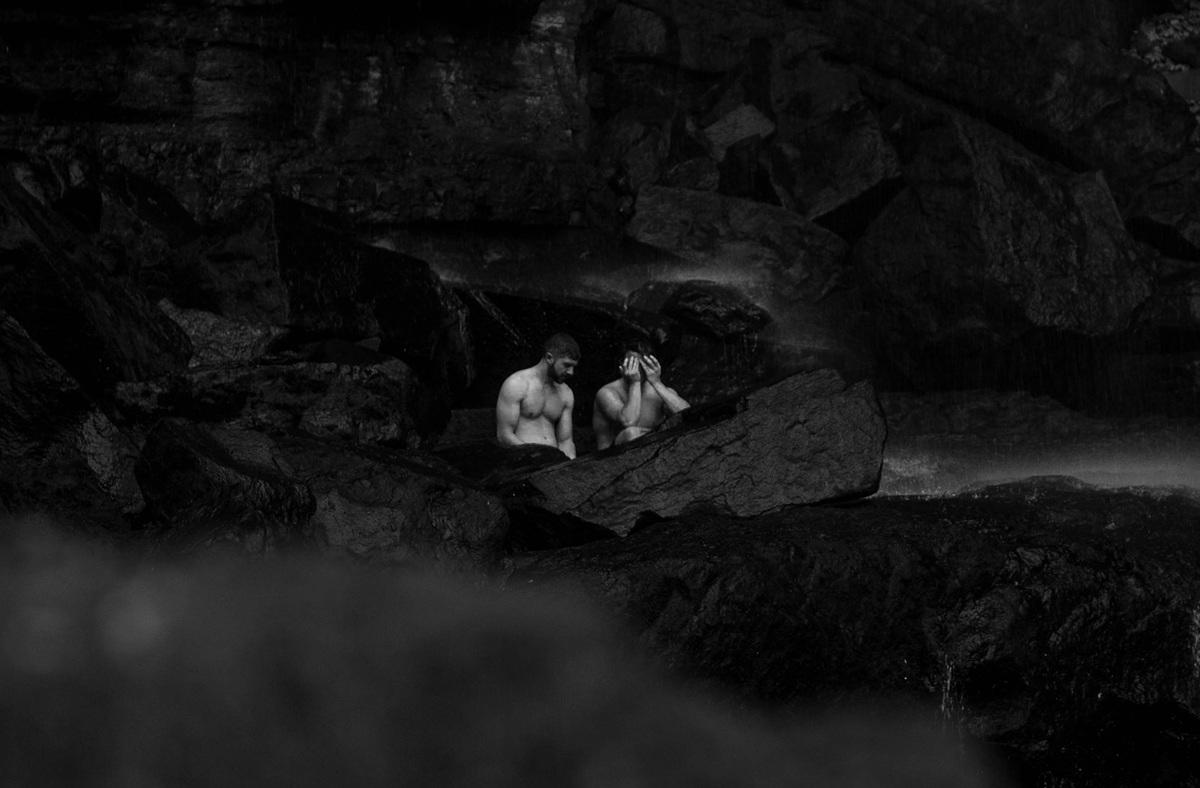 Foreboding black and white picture of two men swimming