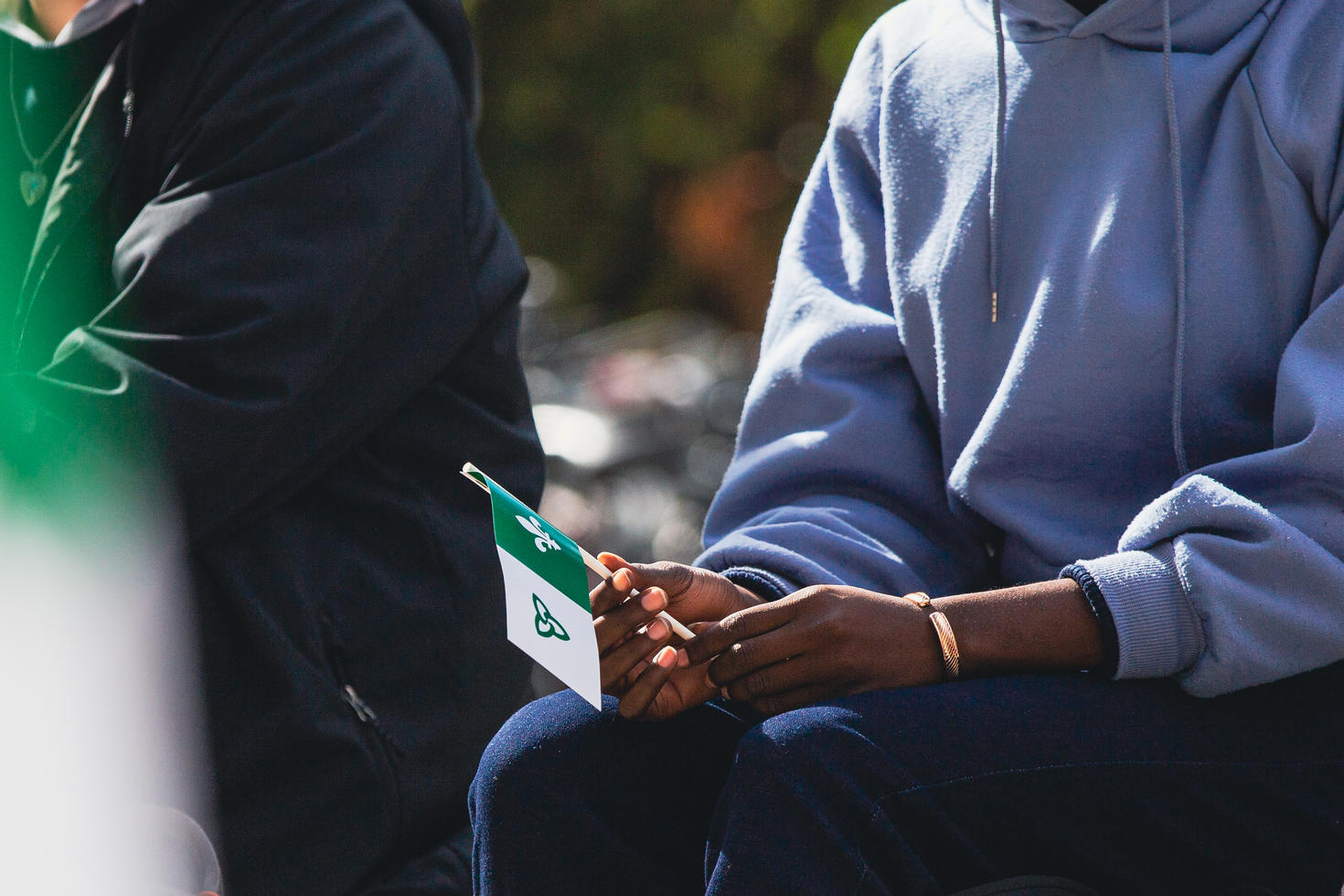An individual holding a Franco-Ontarian flag.