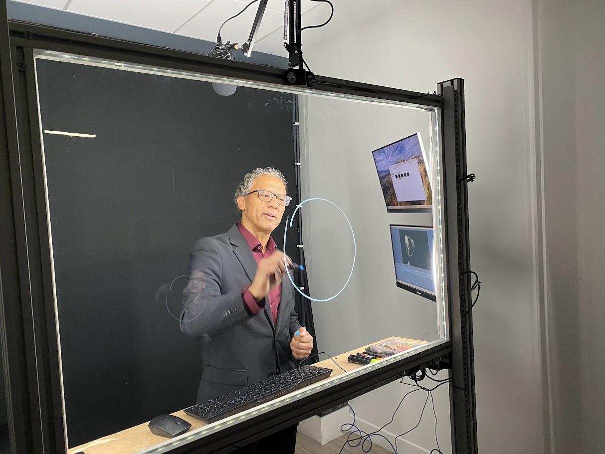 Professor using the lightboard for a virtual class