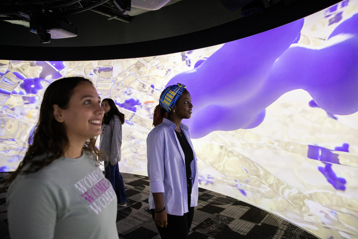 Three students in the immersive cylinder
