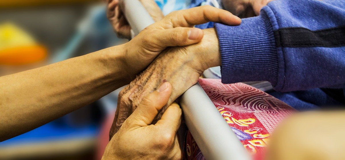 Someone touching a senior's hand