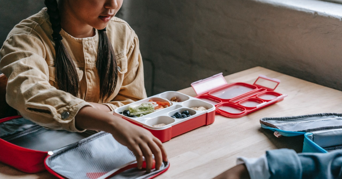 A child opening a lunch box