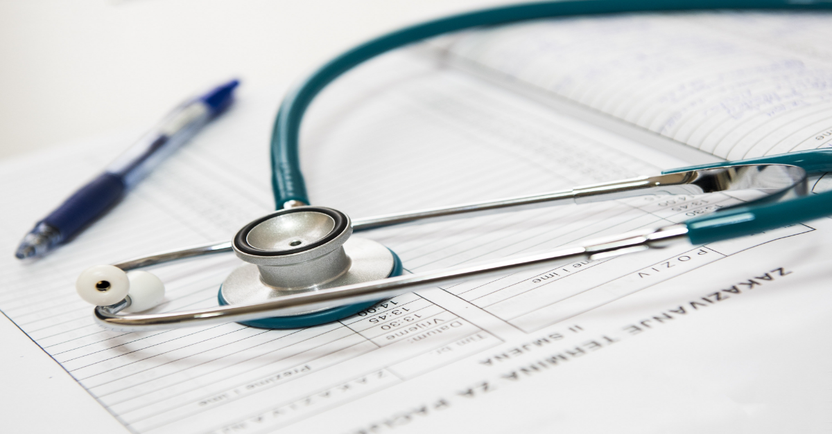 Doctor's stethoscope placed on a hospital chart