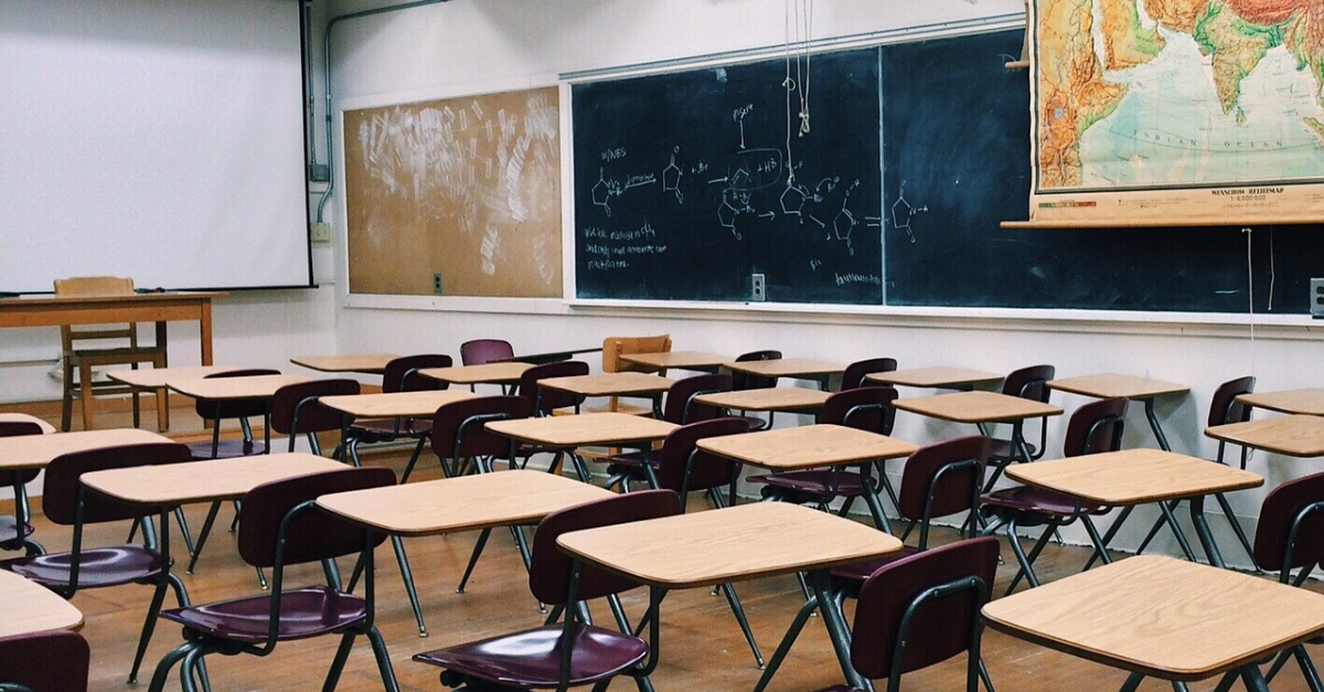 A classroom with desks and chairs