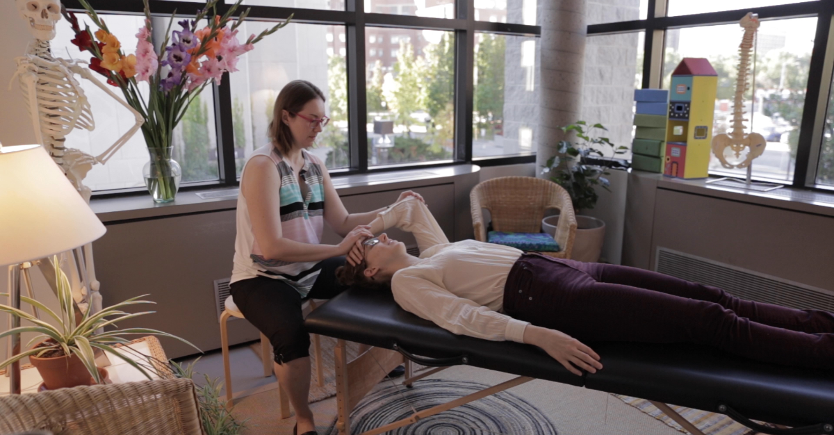 A physiotherapist works on a musician's arm