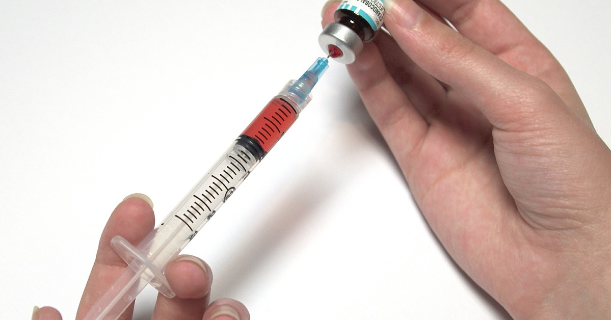 A doctor preparing to give a vaccine