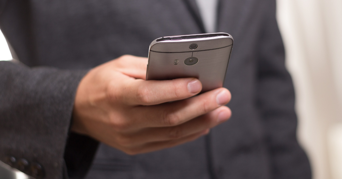 A young person holding a smartphone.