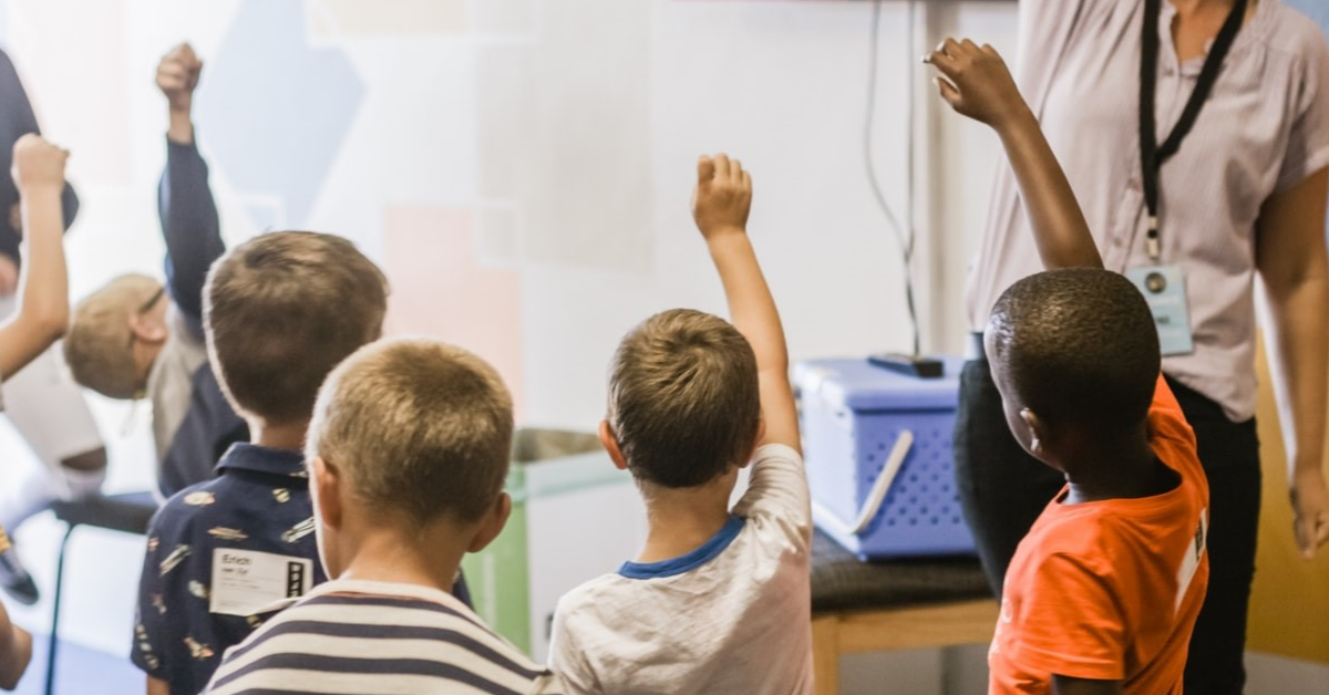 Young students asking questions in class.