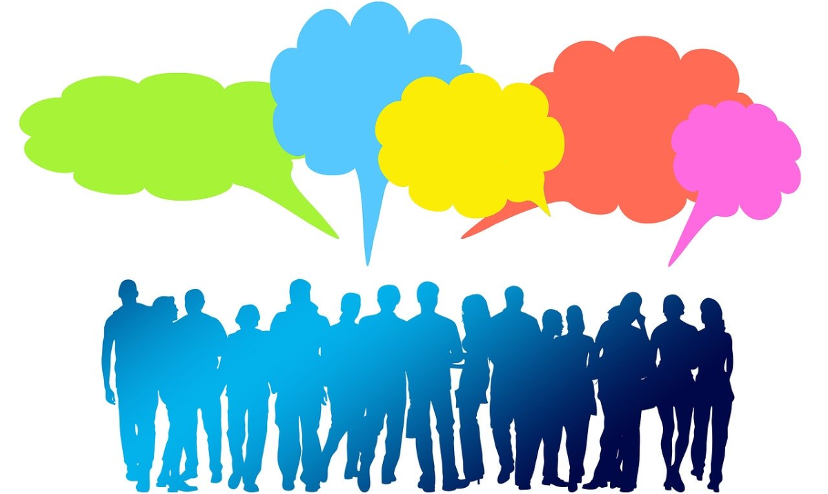 A group of people with multicolored speech bubble above them