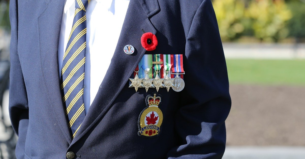 Canadian Veteran with a poppy and medals on his jacket.