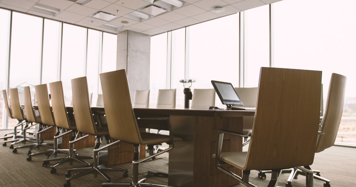 A large table in a conference room with empty chairs