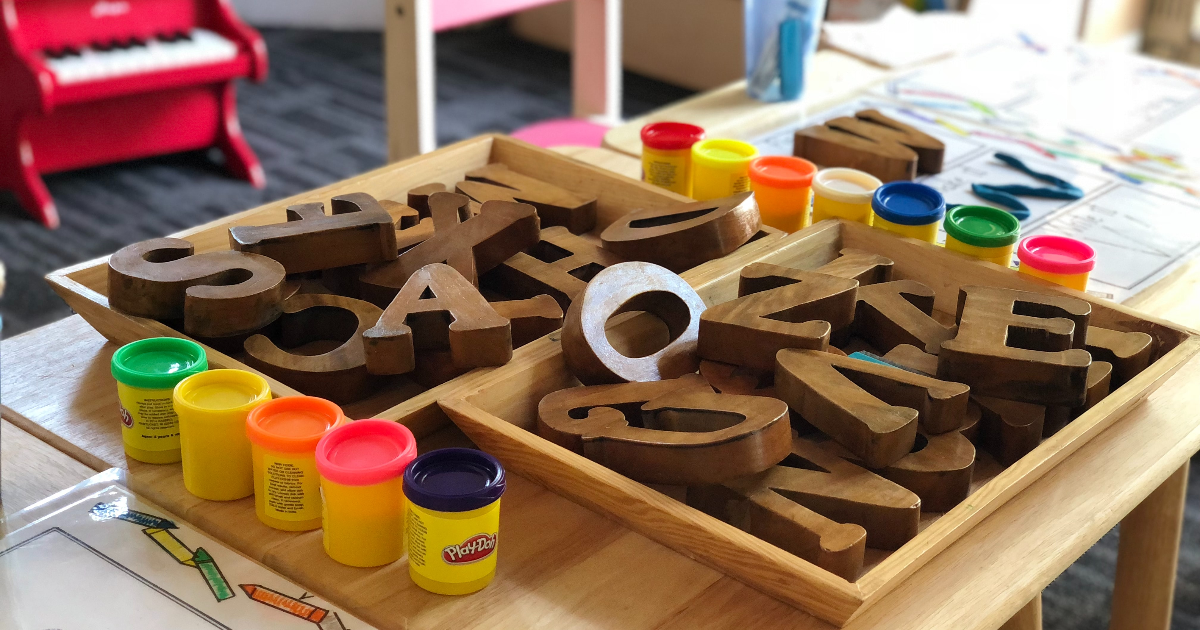 A table with pencils, letters, play dough and other activities for kids