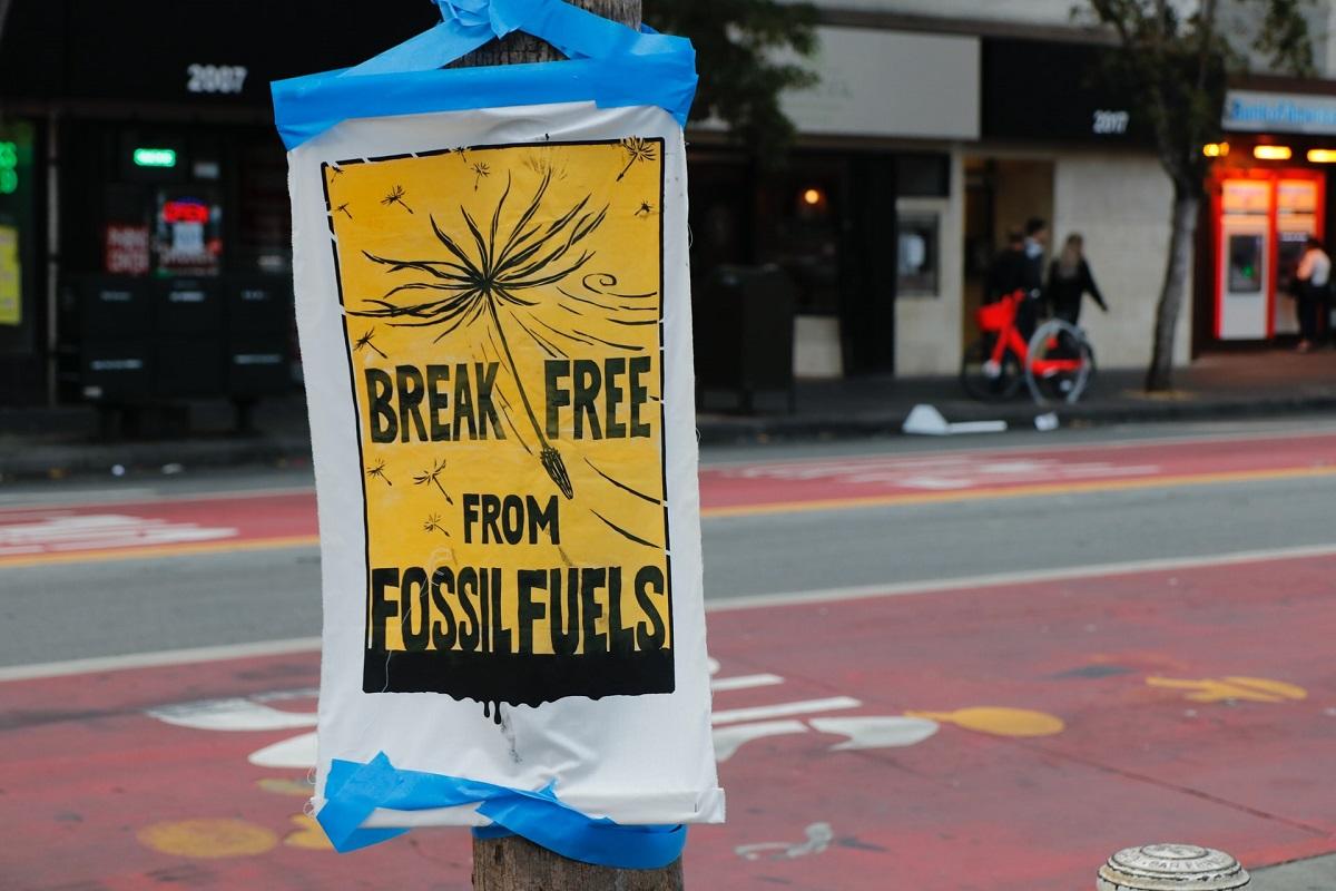 Sign taped to post reading 'Break free from Fossil Fuels'