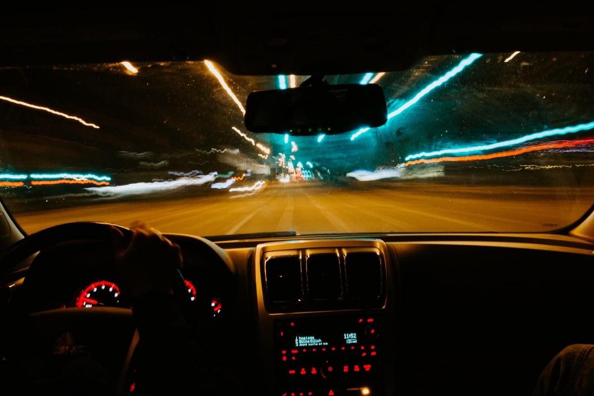 View of blurry streets at night from standpoint of the car's driver