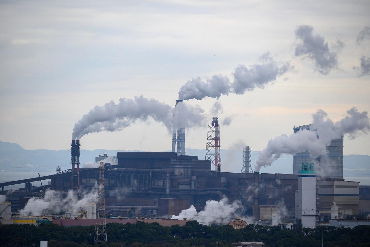 Warehouse chimney stacks emitting smoke
