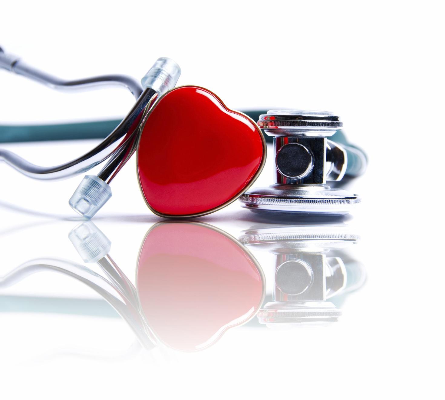 Stethoscope on a table with a red heart