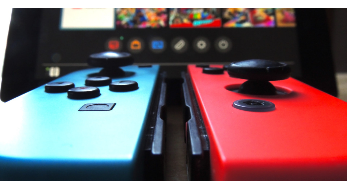 2 Nintendo Switch controllers with a screen in front
