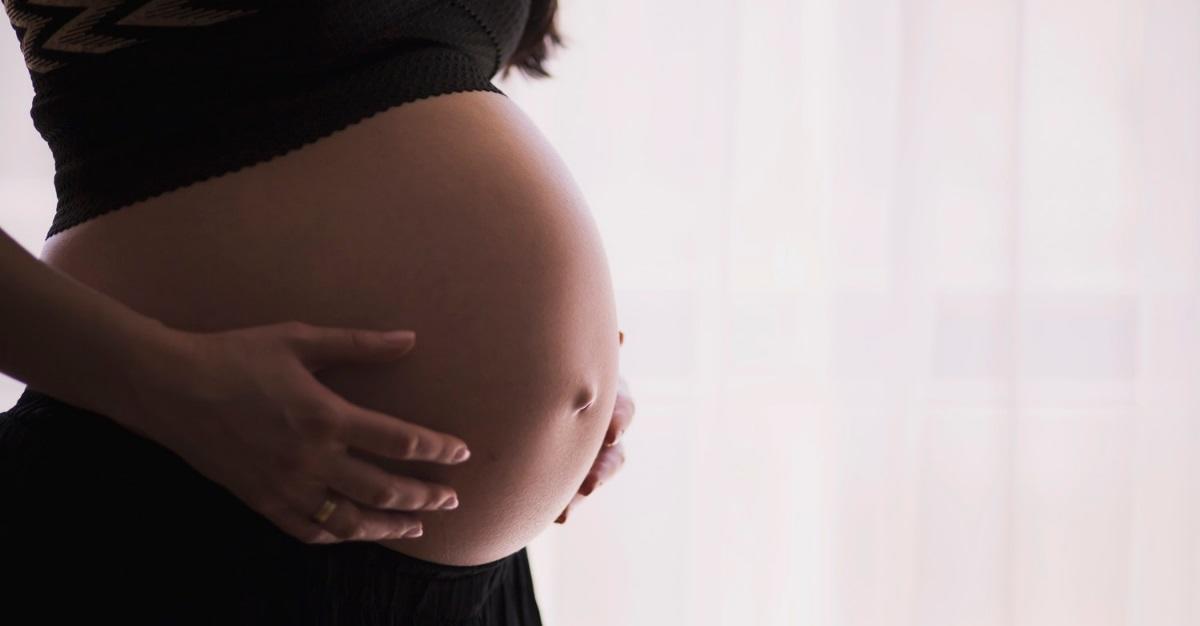 pregnant mother touching her belly