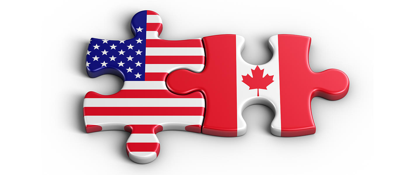 Deux morceaux de casse-tête collés montrants les drapeaux des États-Unis et du Canada