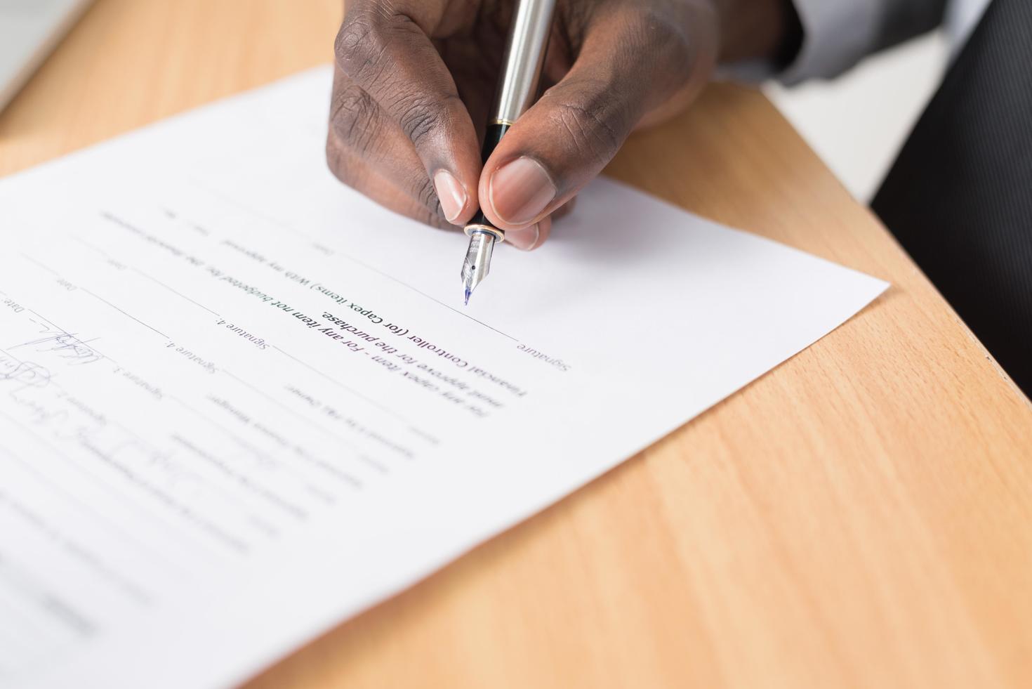 Hand filling out a form