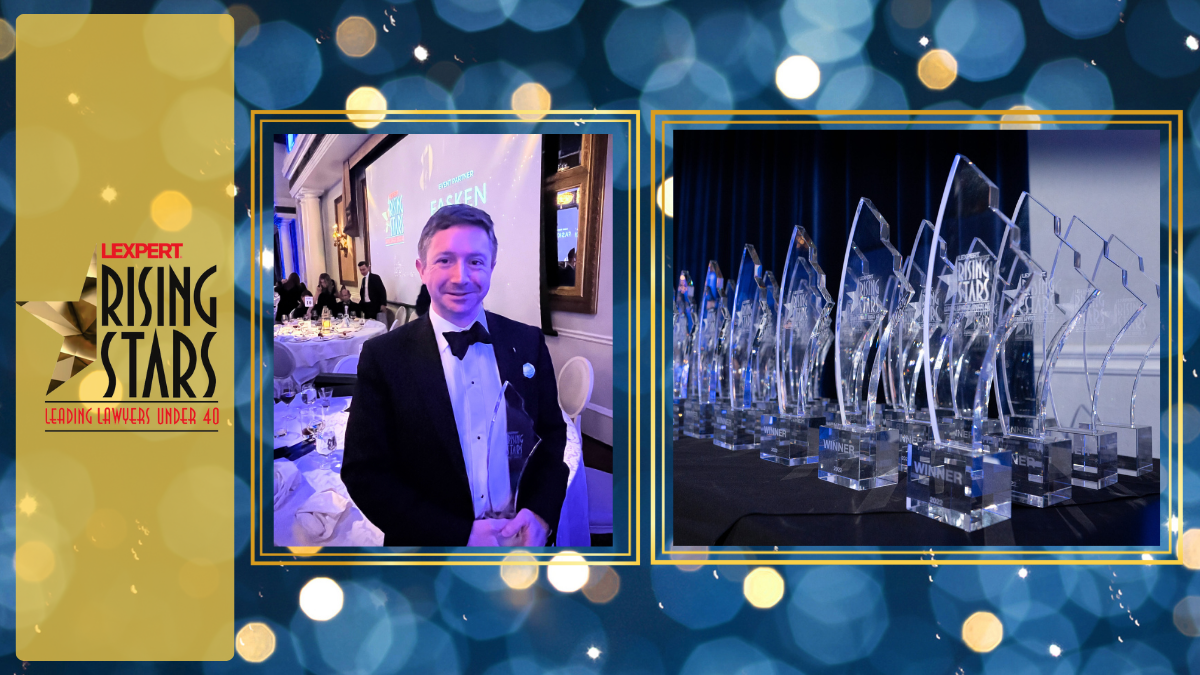 a man wearing a tuxedo stands looking at the camera holding an award in his hands