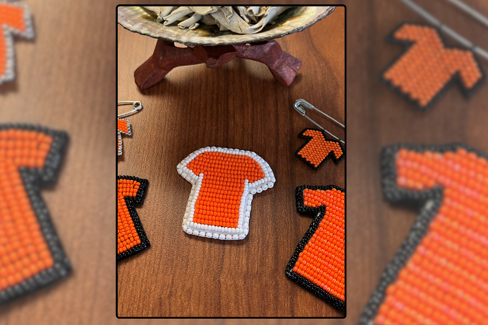 beaded pins shaped and coloured like orange tshirts.