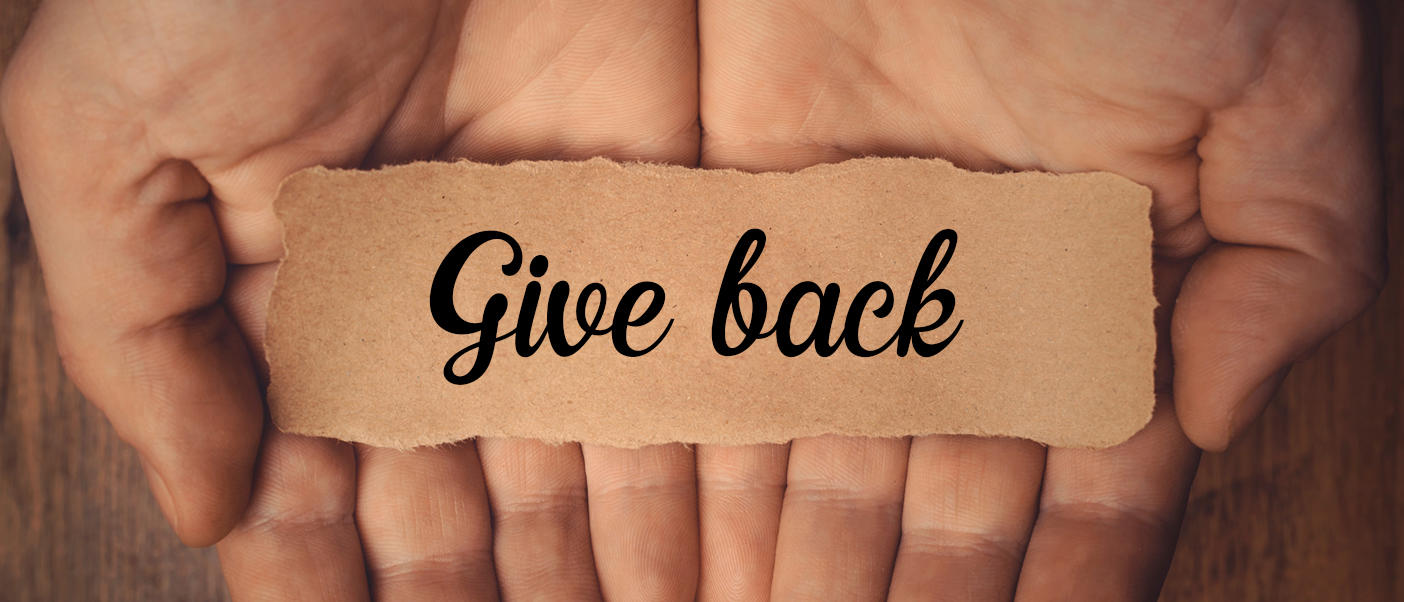 hands holding the words Give back