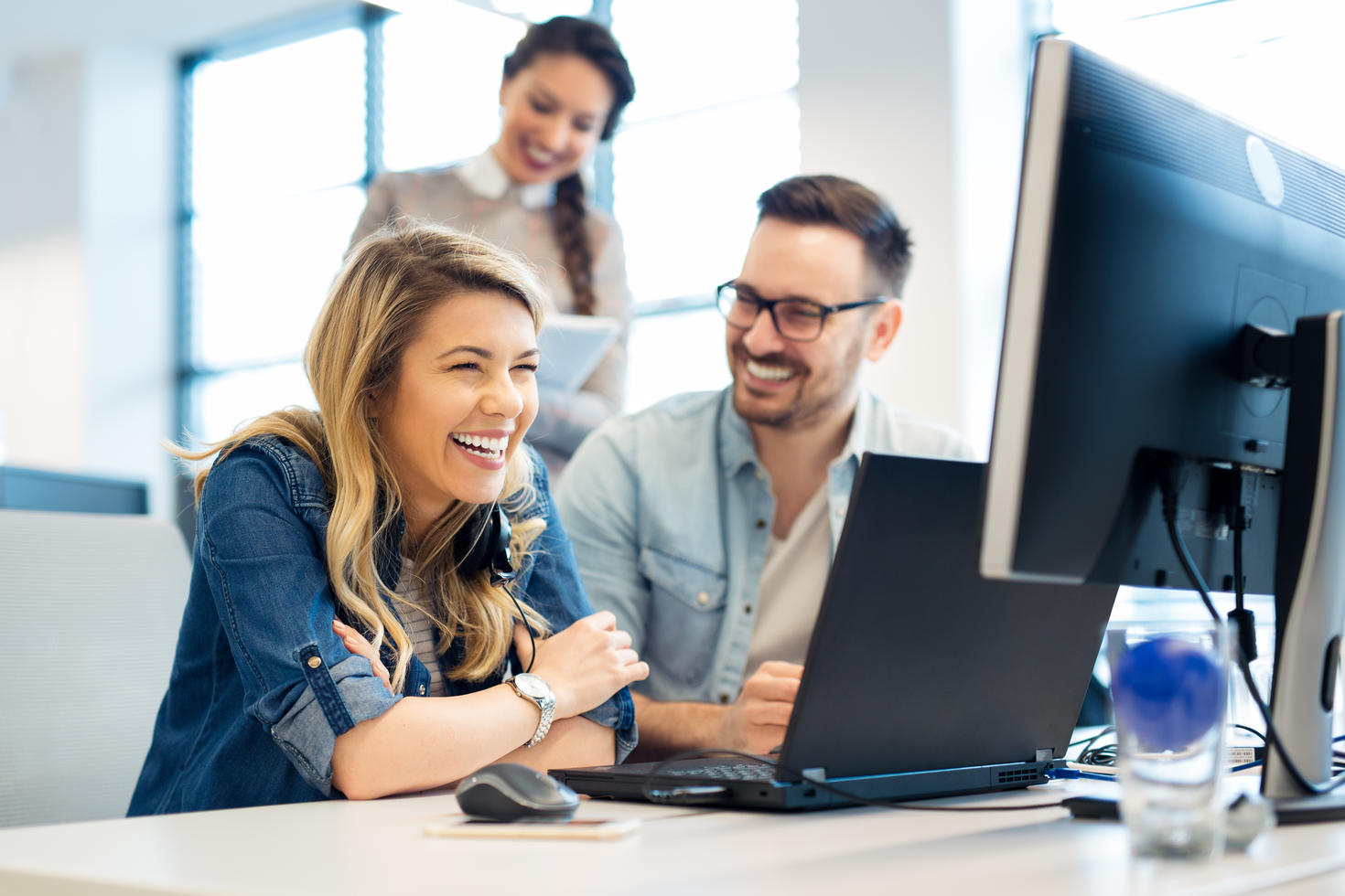 Woman with laptop and colleagues