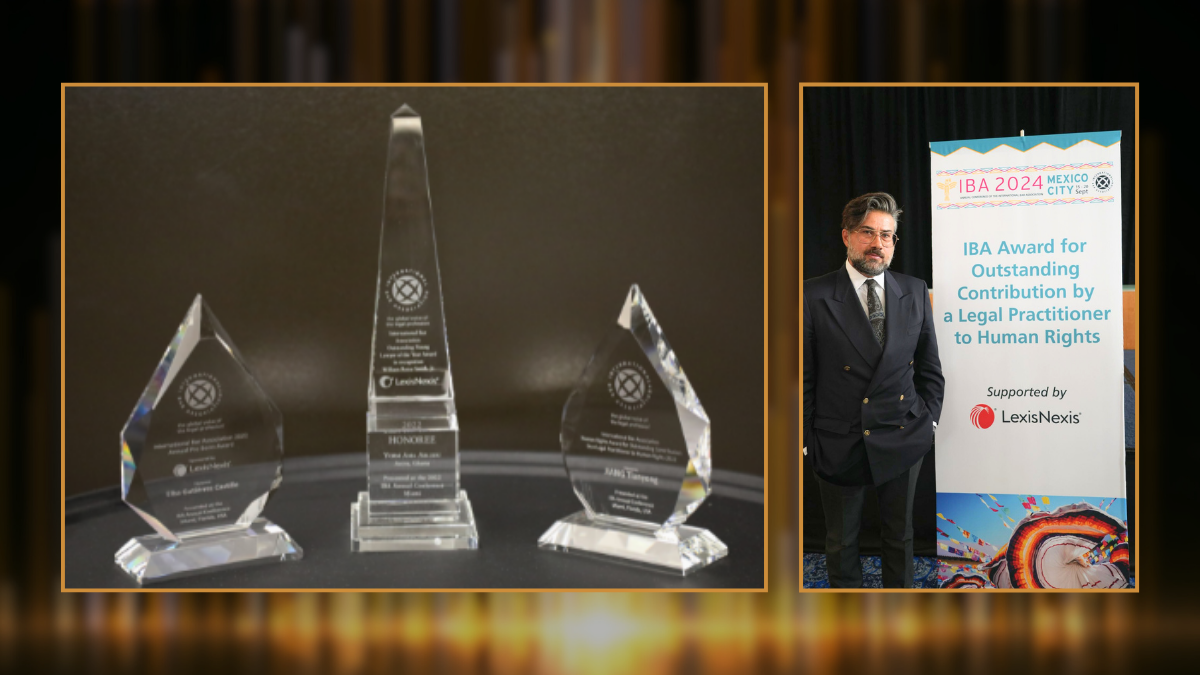 On the left are three glass awards sitting on a surface. On the right, a photo of a man in a suit standng beside a banner that says IBA Award for Outstanding Contribution by a Legal Practitioner to Human Rights