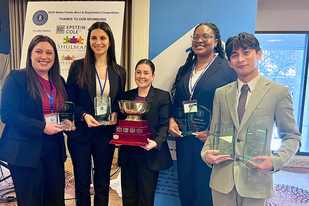 The uOttawa team for the Walsh Family Law Moot. Five people stand holding awards.