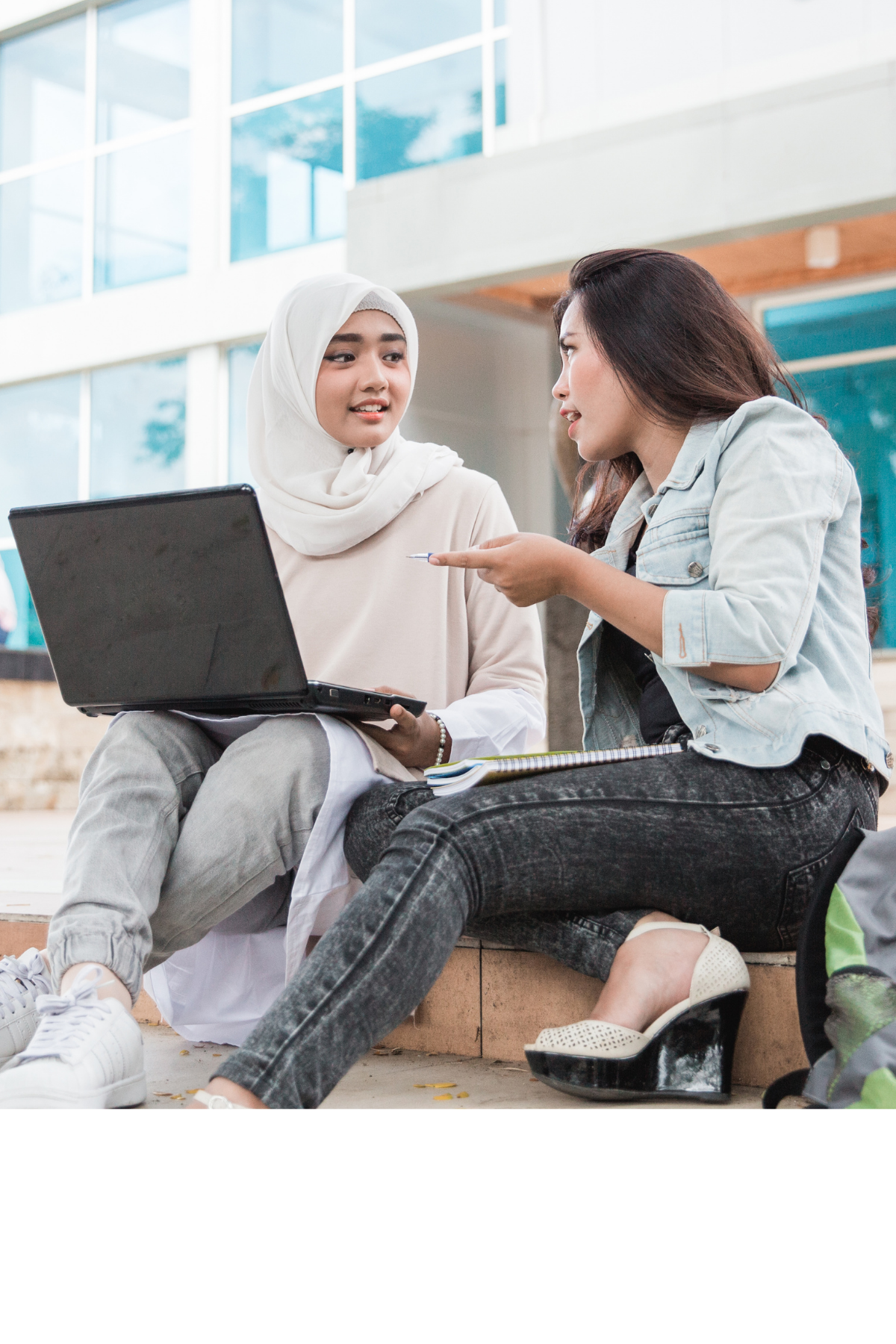 Two students smiling in classroom