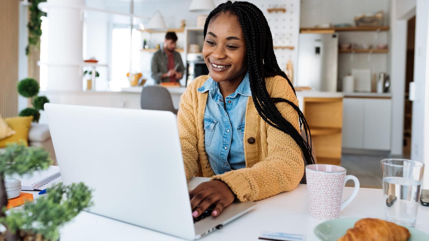 A person typing on her laptop