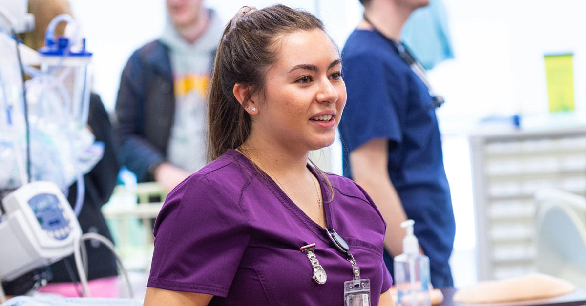 Jeune femme portant un uniforme d'infirmière dans un établissement médical.