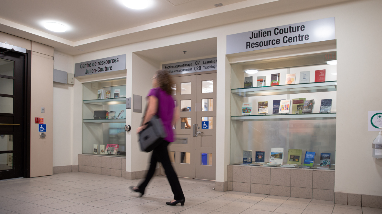 An image of a lady walking in front of the Julien Couture Resource Centre.