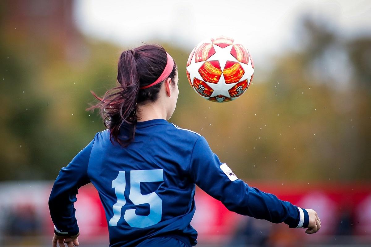 Female soccer player chasing ball