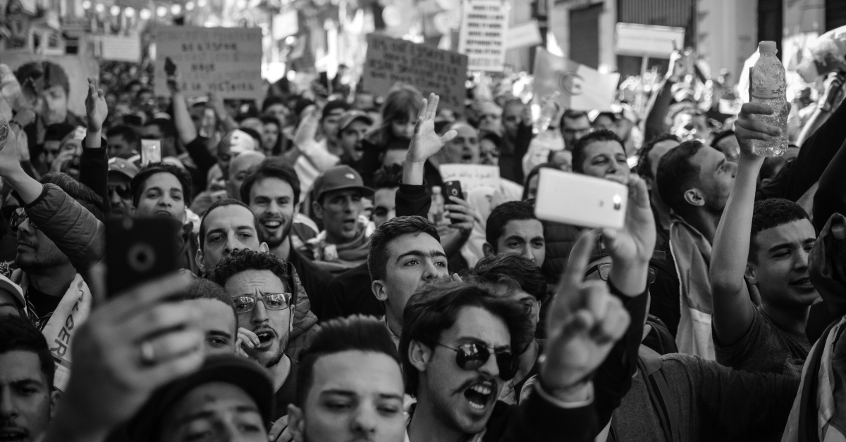Crowd marching in the street during a popular demonstration.