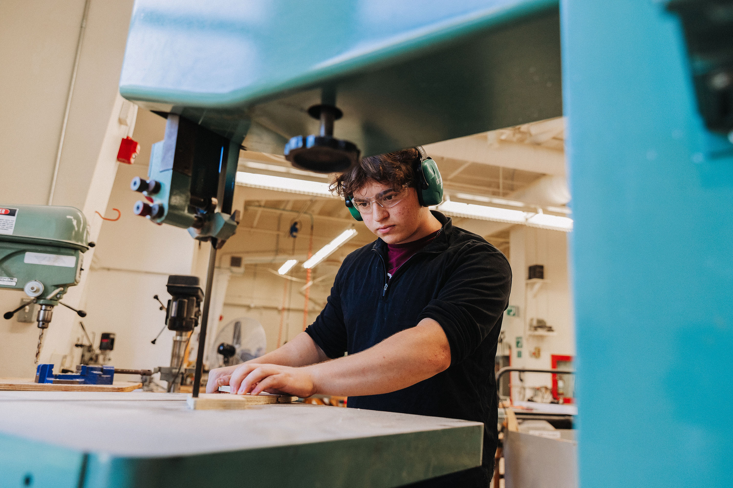 Student working on a wood piece