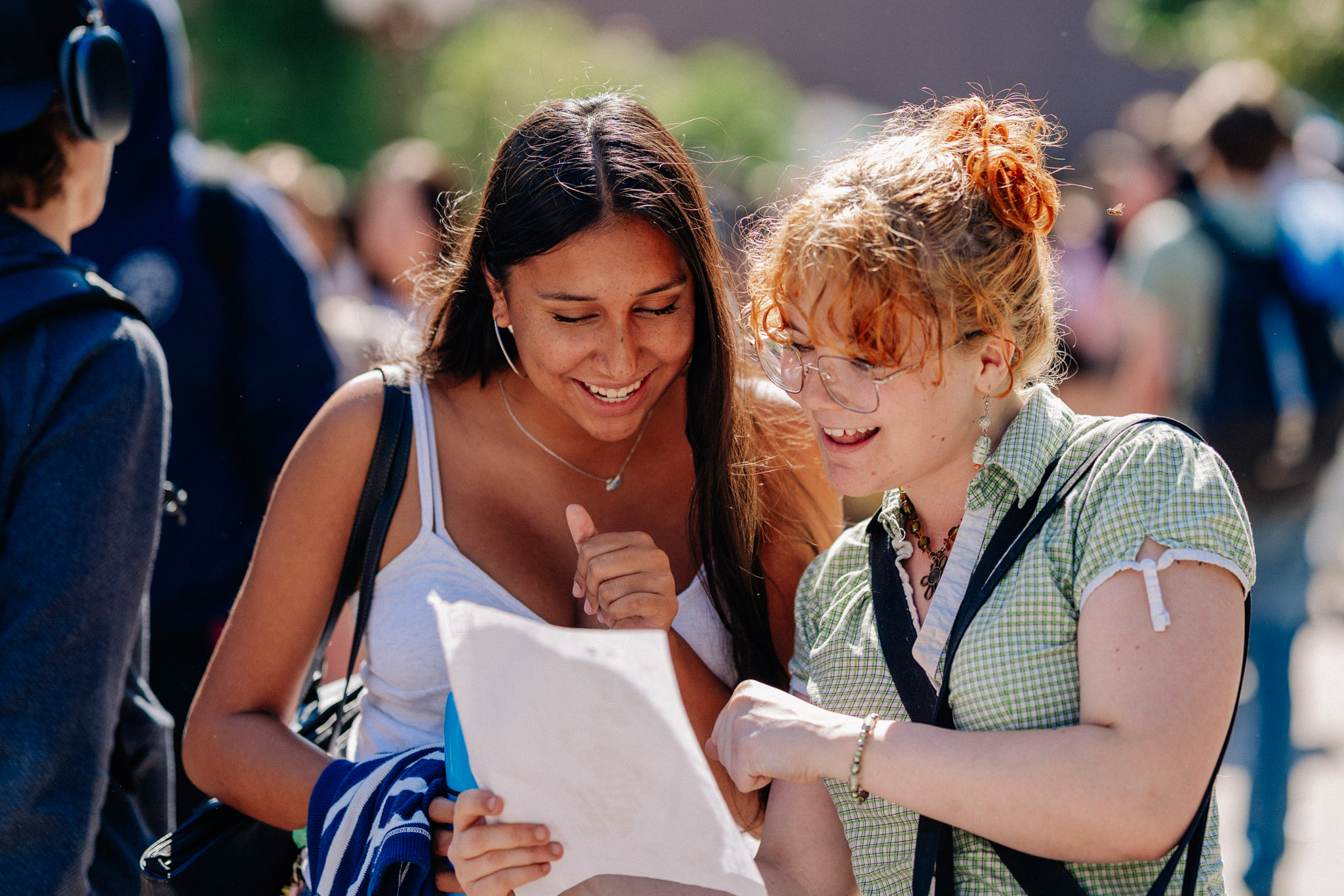 Students looking at papers and smiling