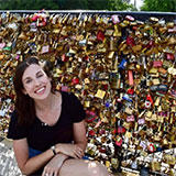michdolla in front of a bridge covered in love locks