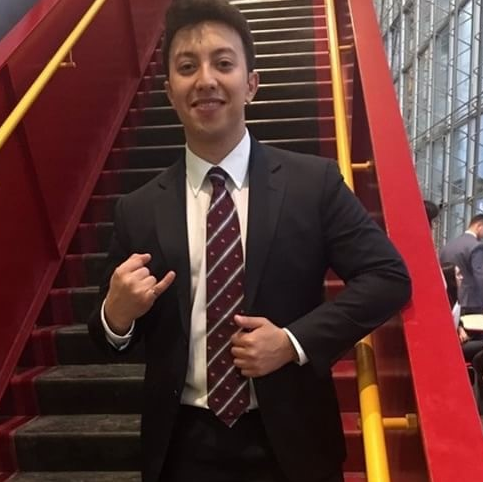 saif-elh in staircase of SITE pavillion showing off his ring