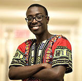 stevesangwa arms crossed wearing an african shirt