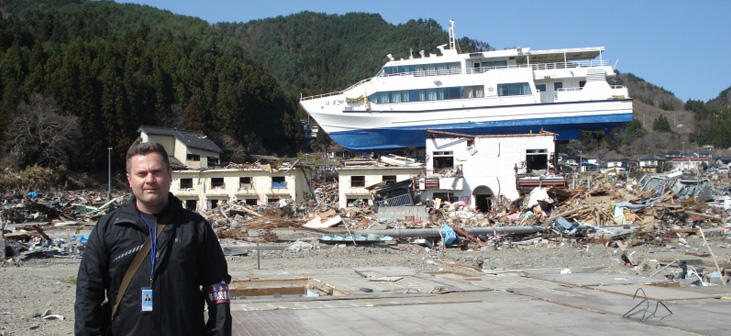 Professor Ioan Nistor stands near a ship destroyed by a tsunami in Japan 